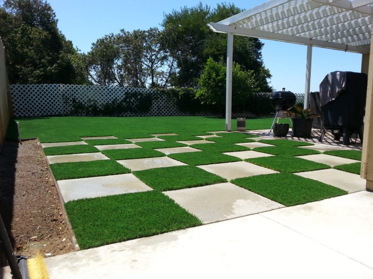 Checkerboard pattern of artificial grass and concrete pavers