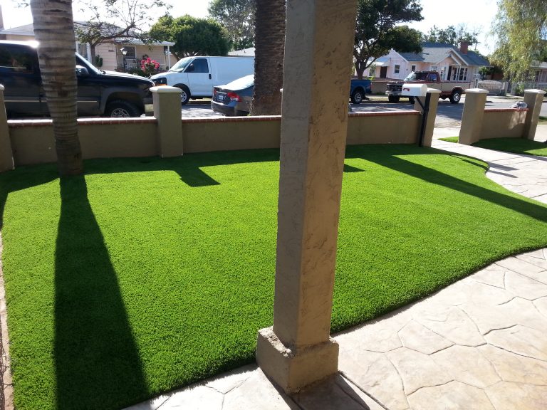 Lush synthetic turf lawn beside a covered patio