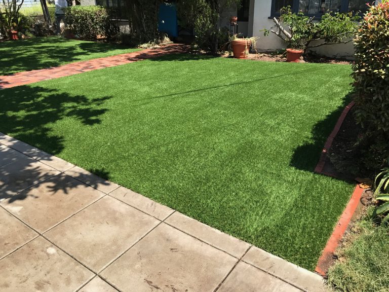 Front yard synthetic lawn with planting beds