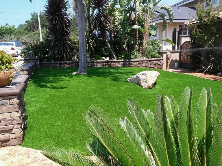 Artificial grass lawn in a tropical landscaped yard