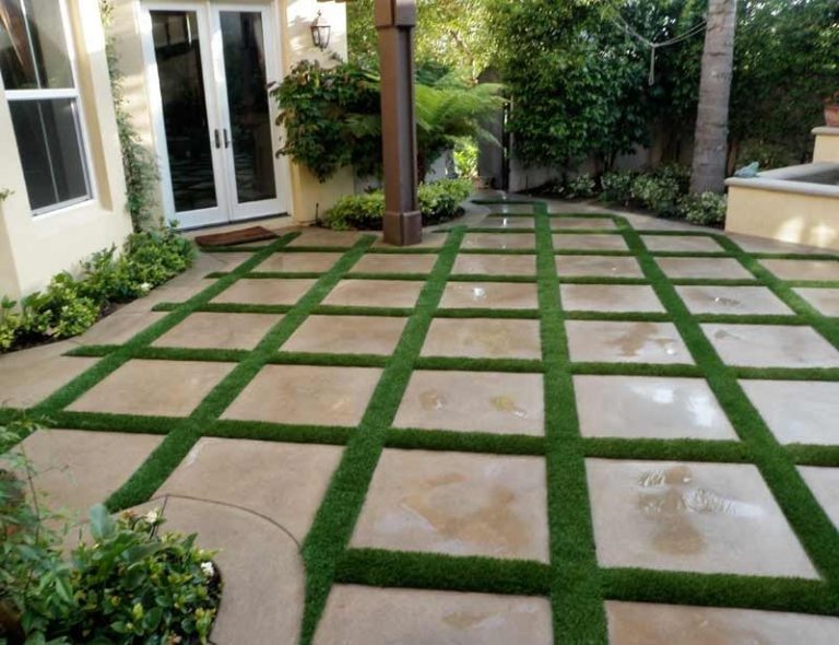 Patio of large pavers with artificial grass joints